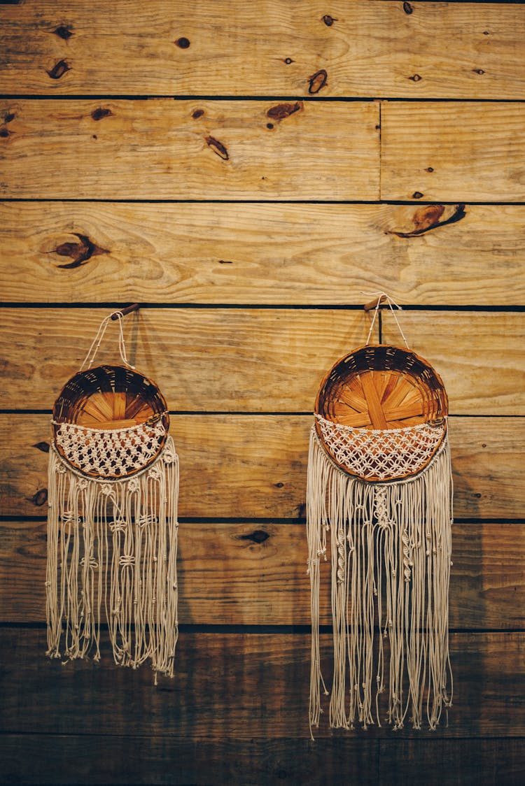 Baskets With Strings Hanging On Wooden Wall