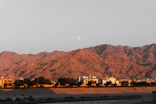 Captivating mountain landscape with a city nestled in the valley during sunset.