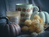 White and Black Ceramic Mug Beside Yellow Flower