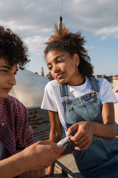 Free Teenage couple on rooftop in city Stock Photo