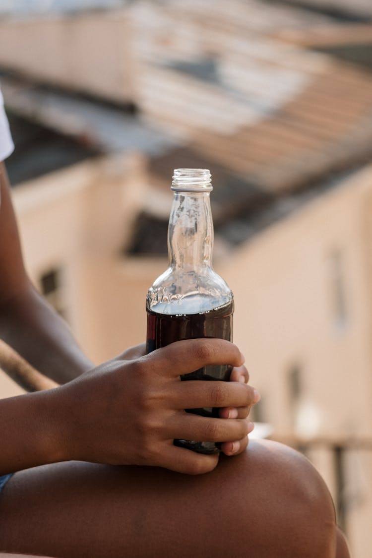 Hands Of Girl Holding Cola Bottle