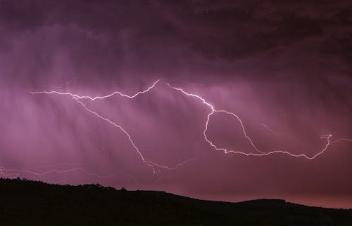Free Lightning Strike Above Mountain During Night Time Stock Photo