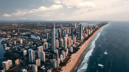 Free Breathtaking aerial view of Gold Coast skyline, beachfront, and ocean waves, capturing urban and natural beauty. Stock Photo