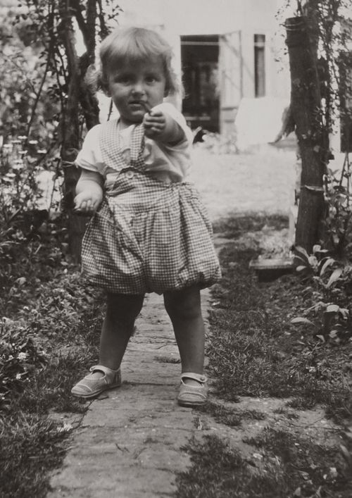Free Charming vintage portrait of a toddler girl in a garden, black and white photography. Stock Photo