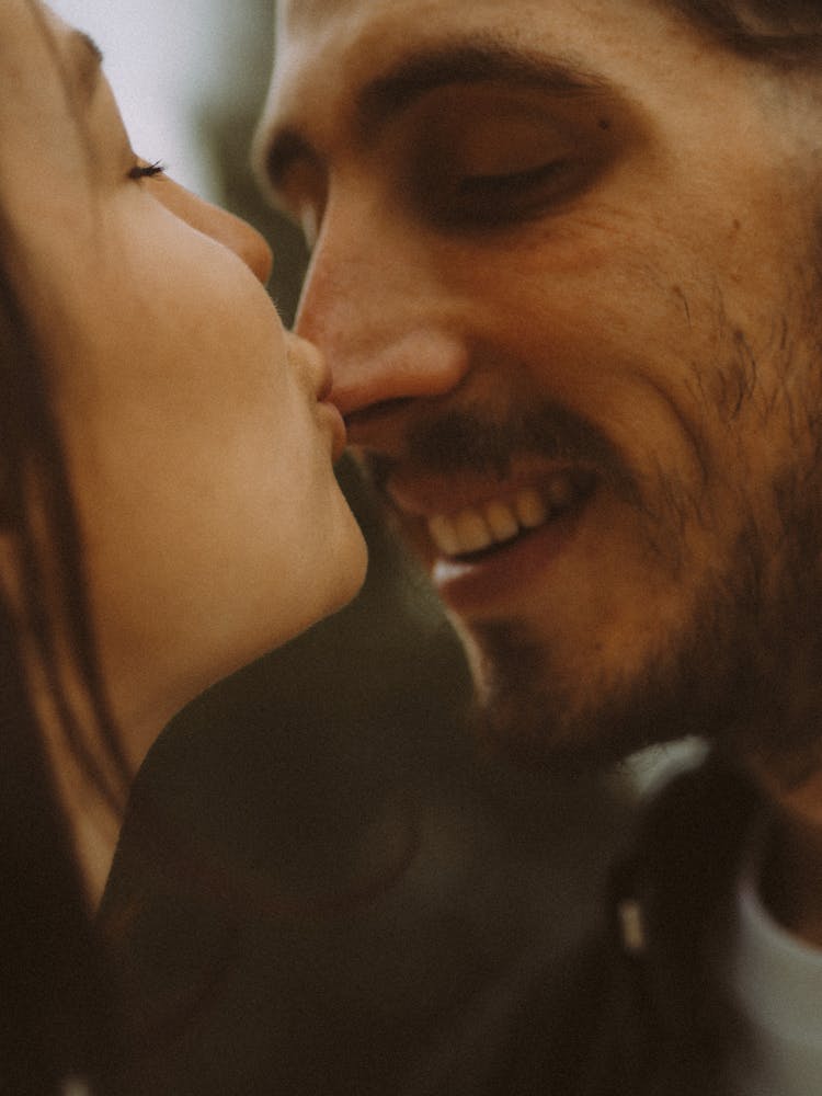 Woman Kissing Nose Of Boyfriend