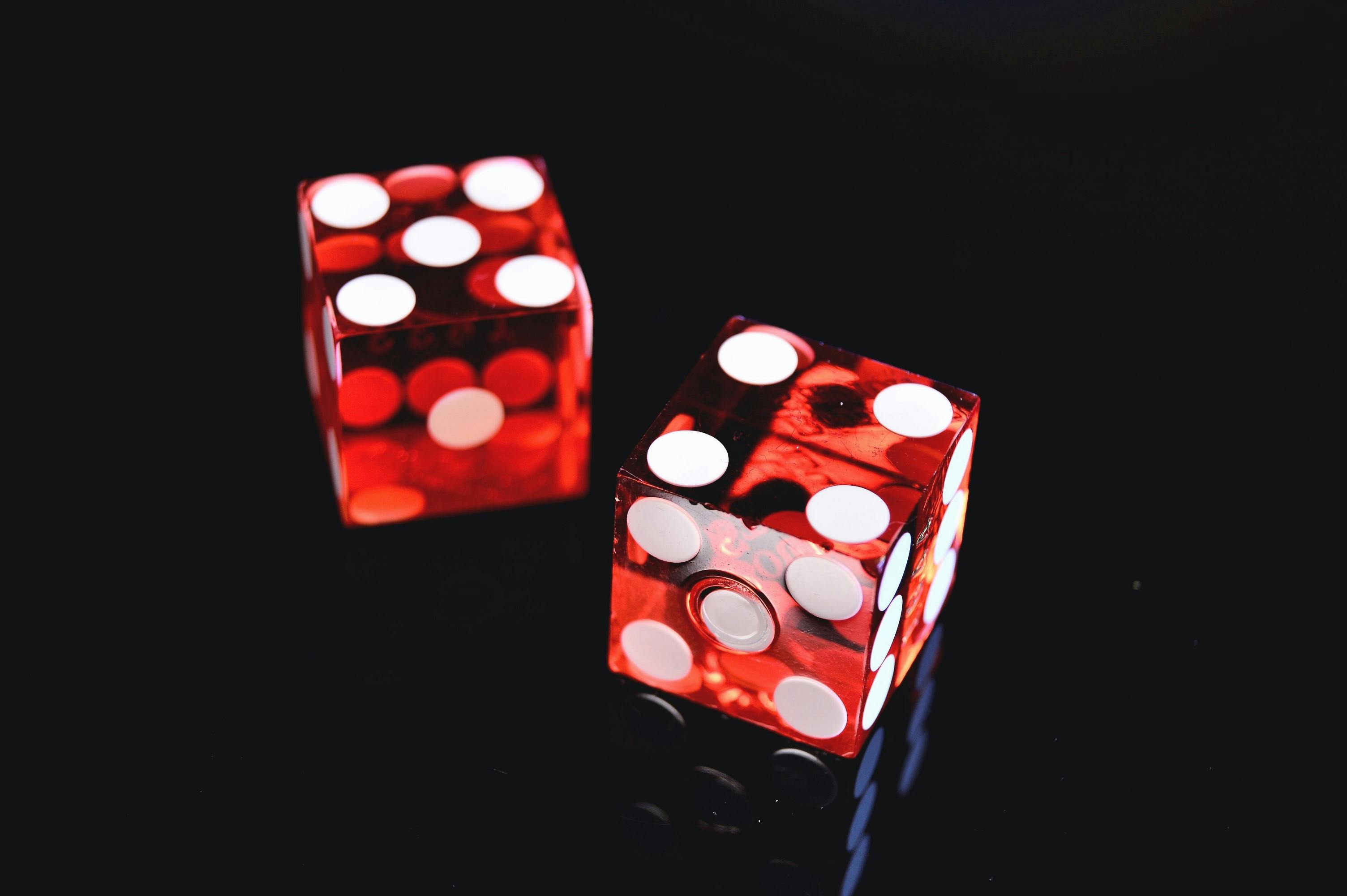 closeup photo of two red dices showing