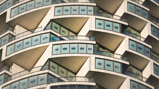 Close-up of a modern skyscraper featuring unique and repetitive balcony designs.