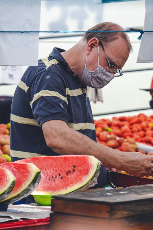 Man Wrapping Sliced Watermelon