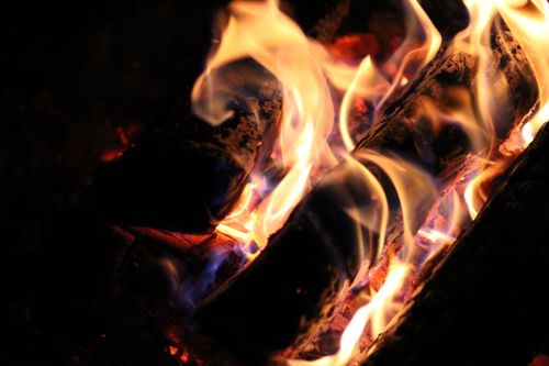 Free Close-up view of wood burning with mesmerizing flames, ideal for warmth concepts. Stock Photo