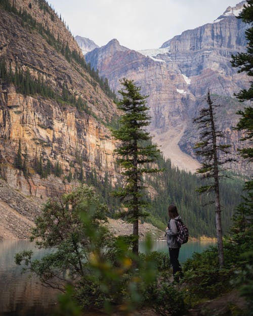 Woman near River among Rock Formations