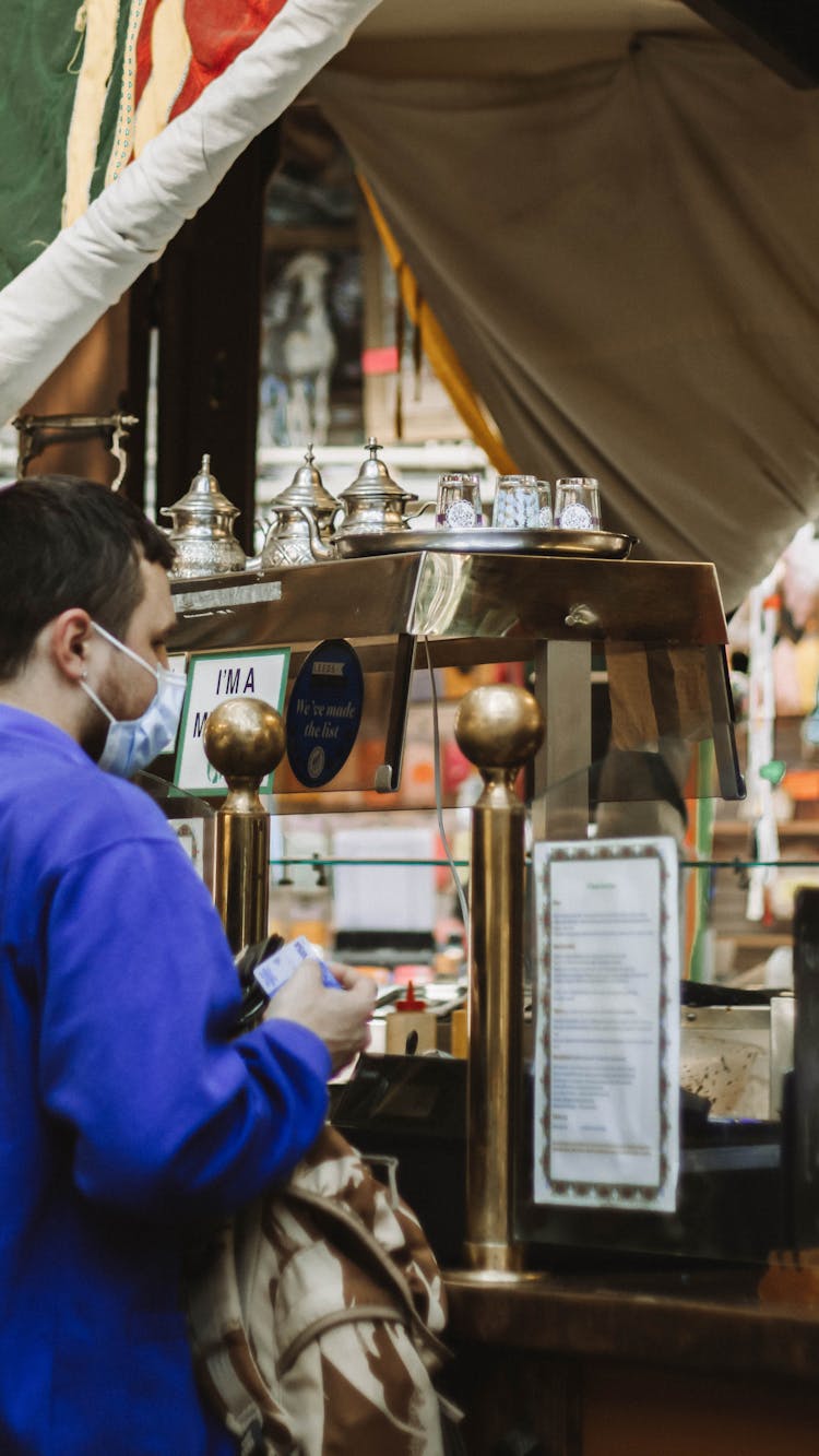 Man Buying In Cafe