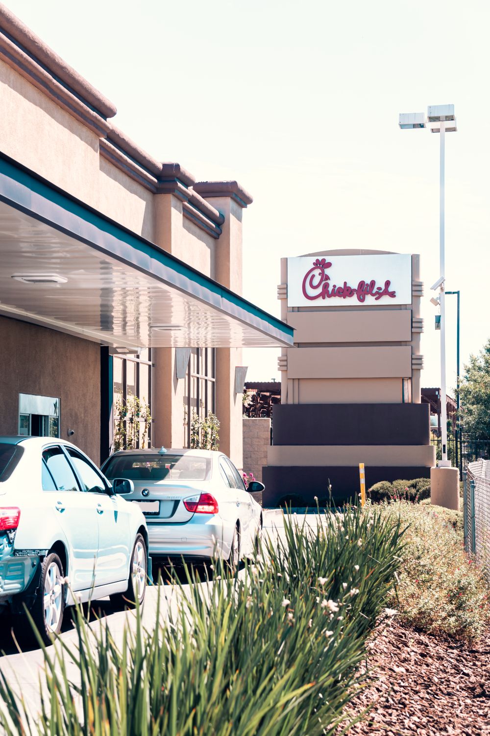 Cars moving through a restaurant drive-through lane