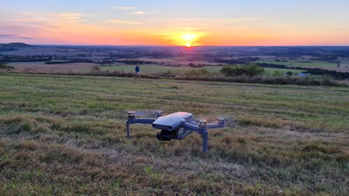 Drone Flying Over a Grass Field