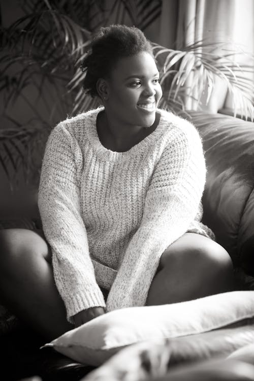 Woman Wearing Sweater Sitting On The Sofa