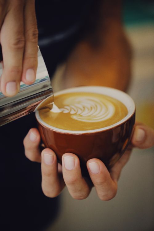 Free Close-up of barista pouring milk into a coffee cup to create latte art. Captured with a Canon EOS 6D. Stock Photo