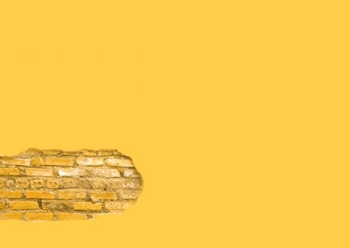 Yellow brick wall with copyspace, ideal for backgrounds and design projects.