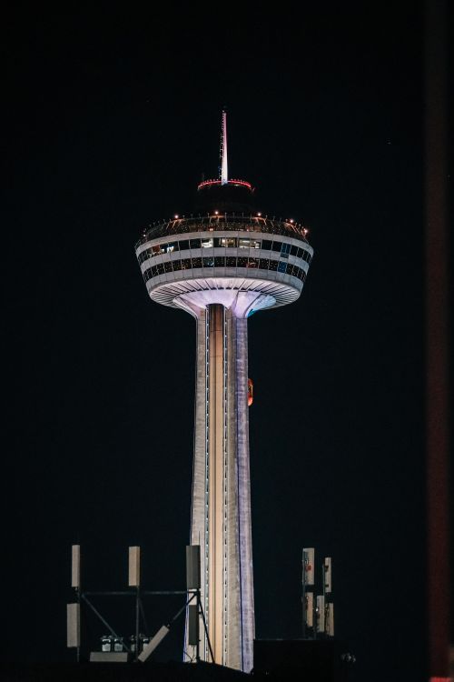 Free The iconic Skylon Tower illuminated against the night sky in Niagara Falls, Ontario, Canada. Stock Photo