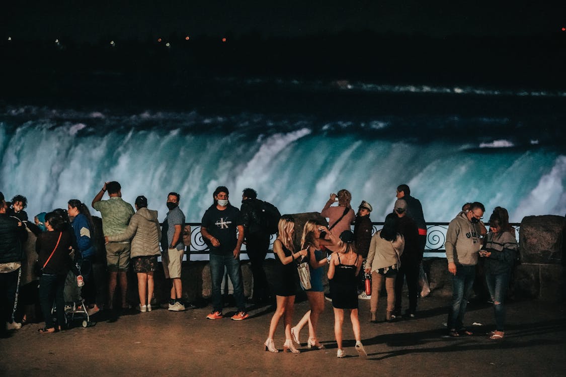 7 Top Places to Visit in Canada that Will Blow Your Mind 8 People Standing Near the Waterfalls