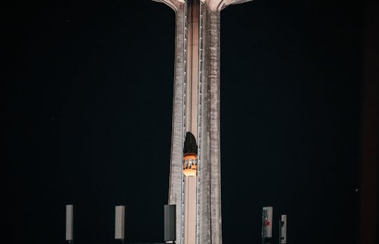 Elevator ascending the illuminated Skylon Tower at night in Niagara Falls, Canada.