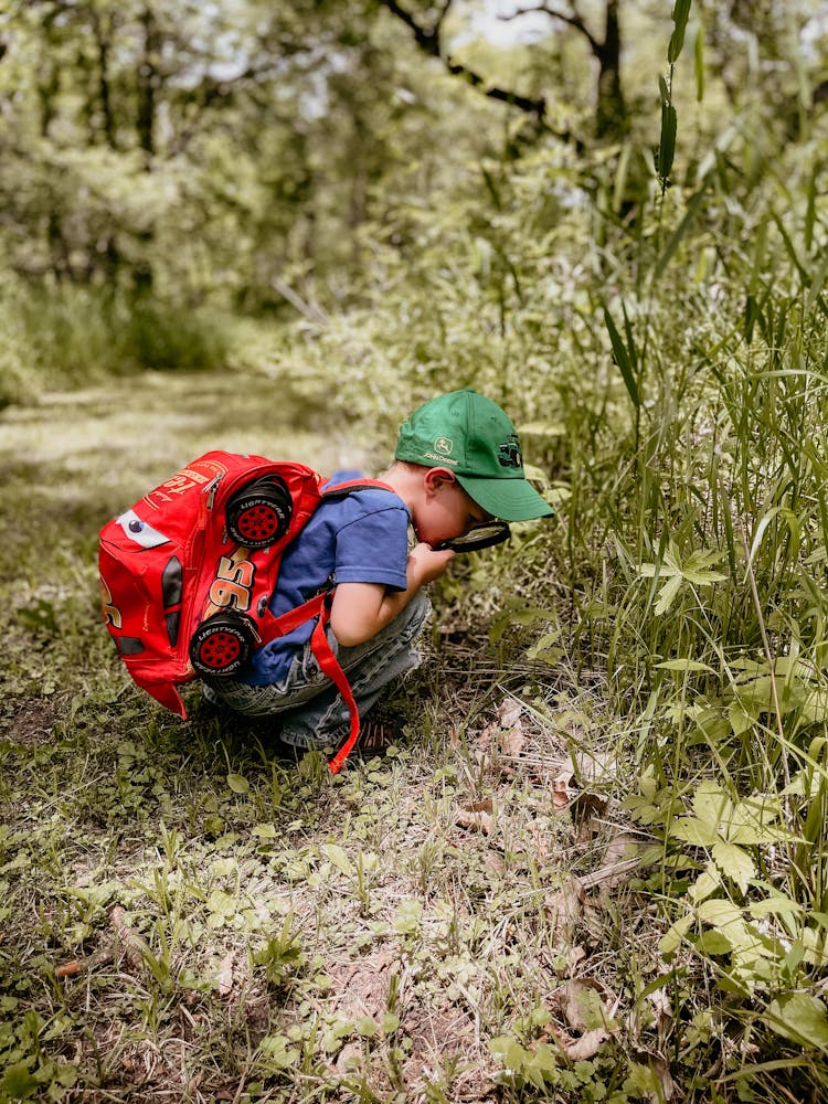 A Kid Sitting On The Grass