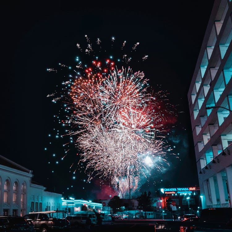 Fireworks Display Over City Buildings During Night Time