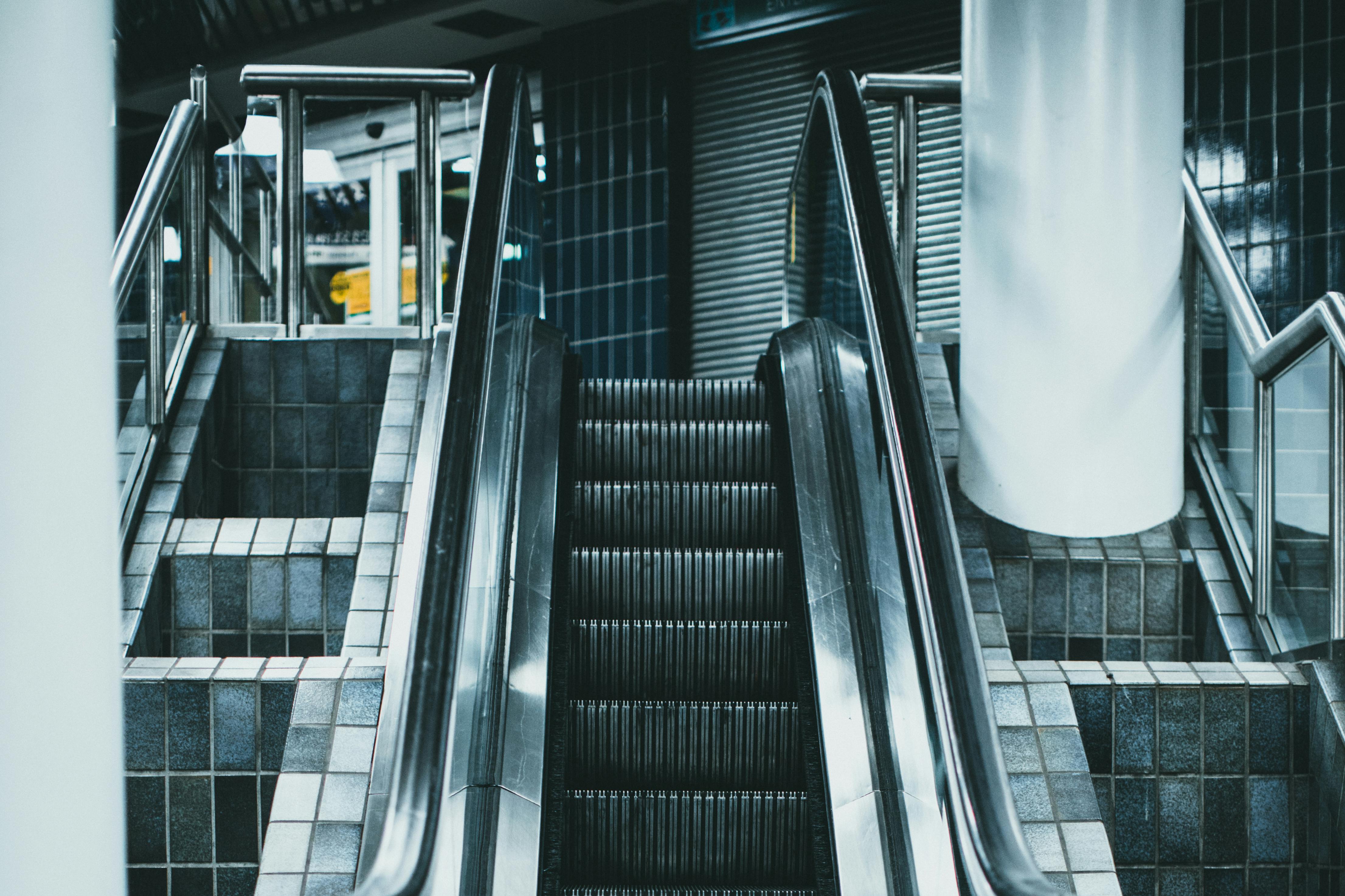 Photo of People on Escalator Inside Building · Free Stock Photo