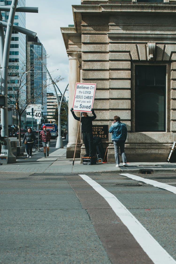 A Man Holding A Poster