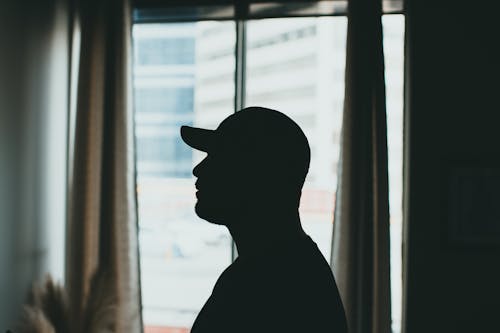Silhouette of a Person Wearing a Cap