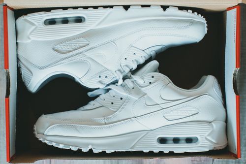 Free White sneakers in a shoebox viewed from above, showcasing clean design. Stock Photo