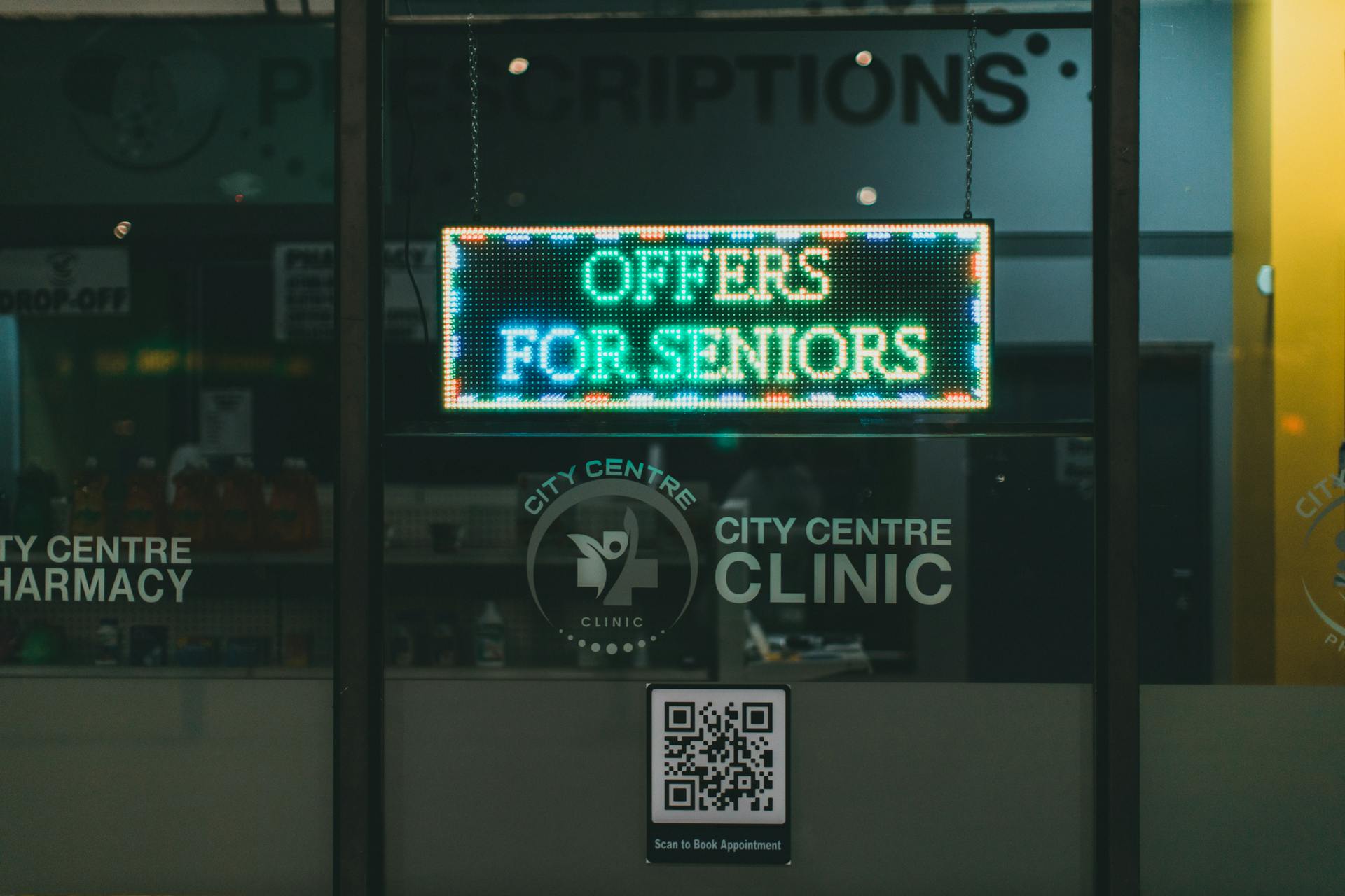 City Centre Pharmacy offers for seniors displayed on illuminated signage, encouraging walk-ins.