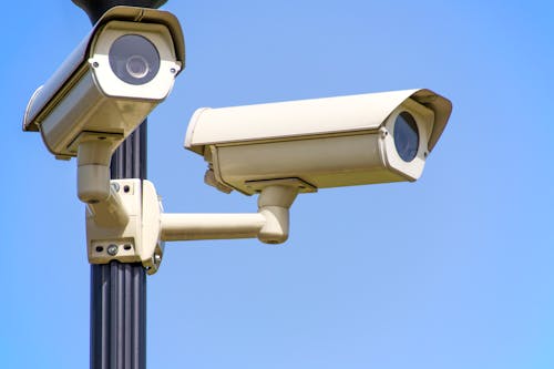Free White 2 Cctv Camera Mounted on Black Post Under Clear Blue Sky Stock Photo