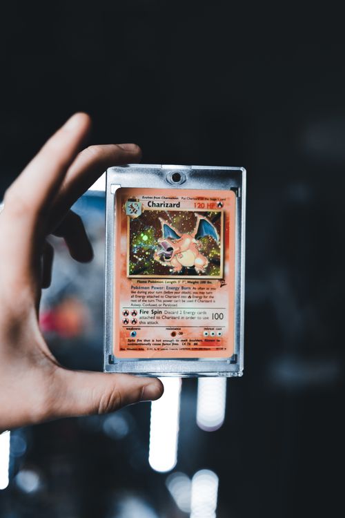 Person examining trading cards under magnification showing the detailed inspection process for card grading