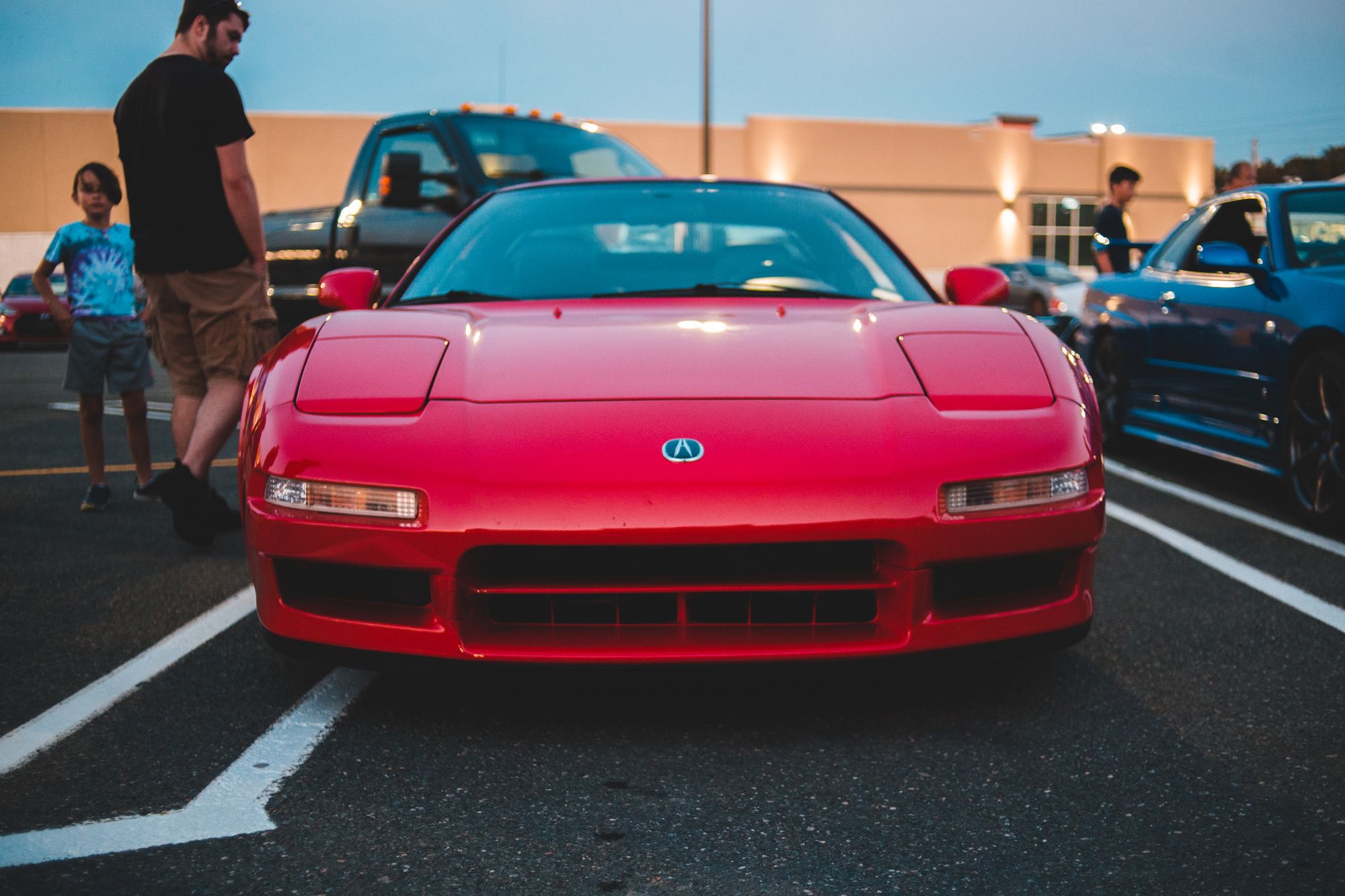 Front-on shot of a first-gen Acura NSX with Acura badge clearly visible, directly matching the original 1990 NSX subject.