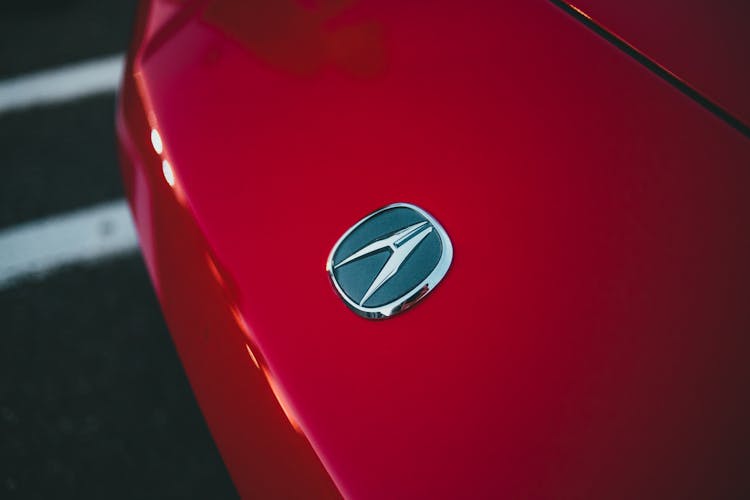 Close-up Of Car Sign On Hood