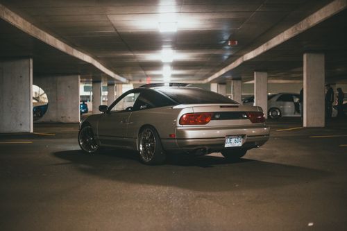 Free A Nissan 180SX sportscar parked in a dimly lit underground garage. Stock Photo