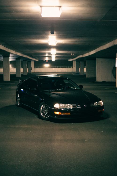 Free Stylish Honda Prelude parked in a dim underground garage, highlighting its sleek design. Stock Photo