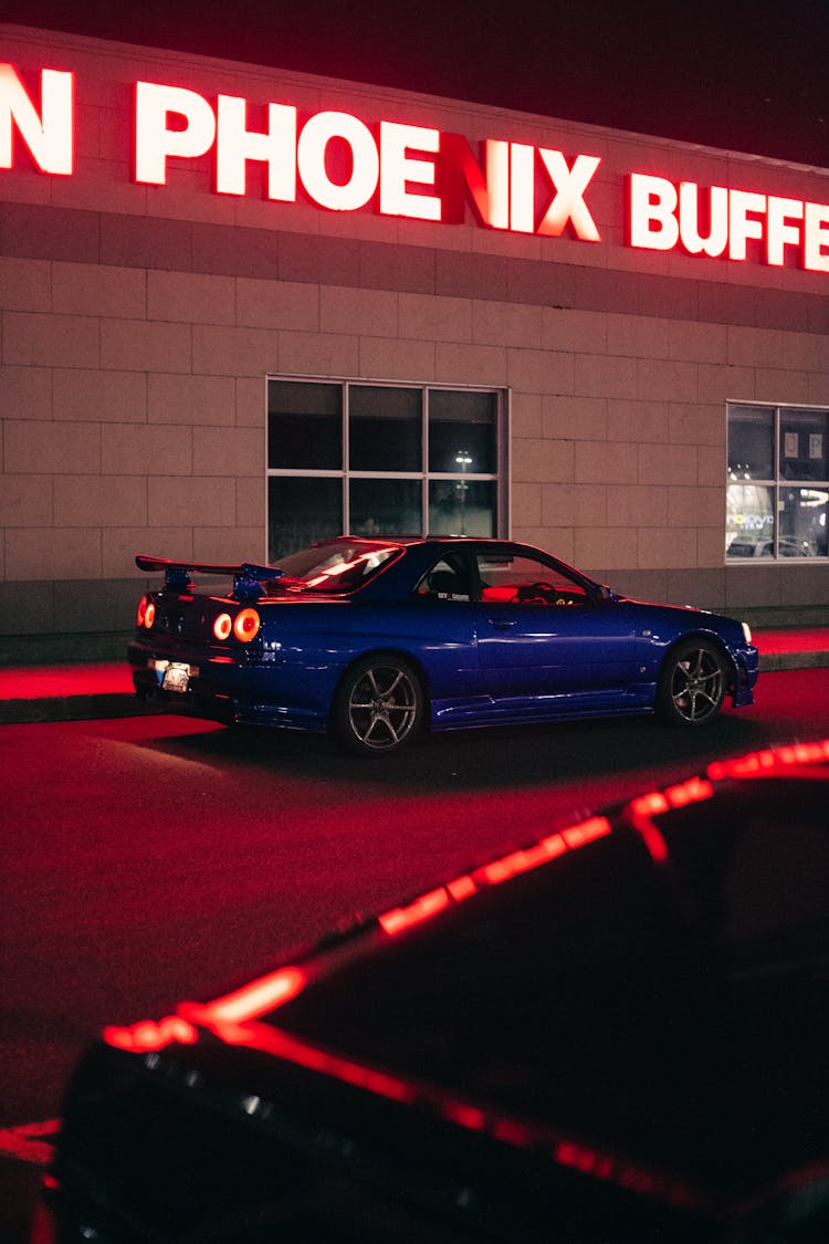 Blue Car Parked Beside A Building