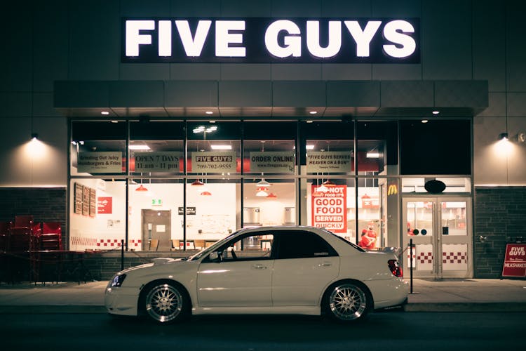 Subaru Impreza Parked In Front Of Five Guys Restaurant 