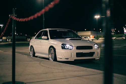 Free Parked White Car on Asphalt Pavement Stock Photo