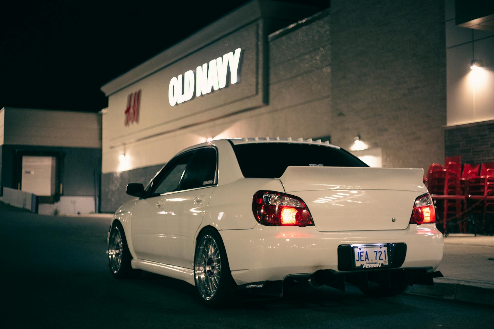 White Sedan Parked Near Old Navy Building