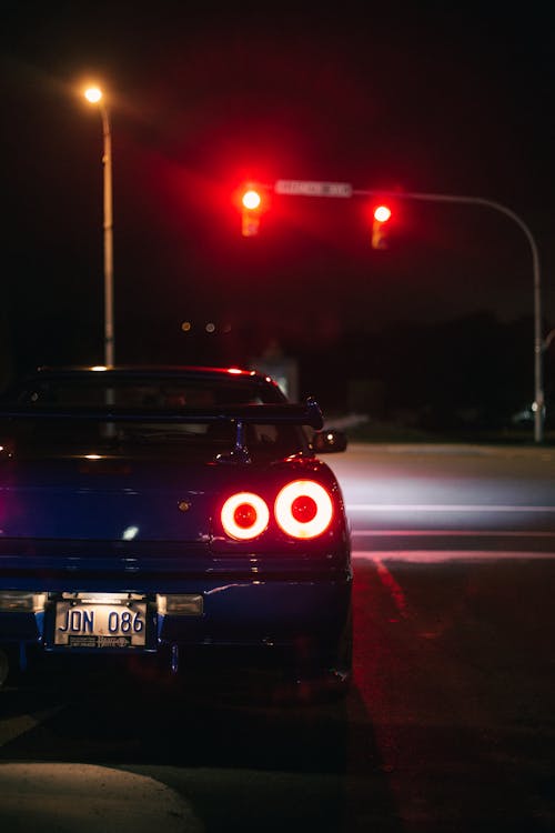 Blue Car Driving at Night