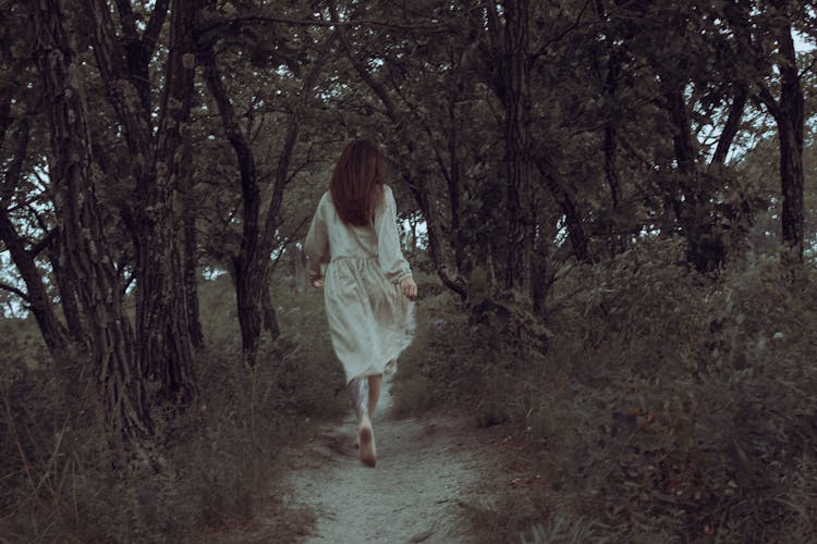 Woman Running On A Path