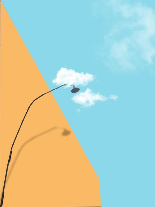 Free Minimalist composition of a street lamp shadow on an orange wall with blue sky. Stock Photo