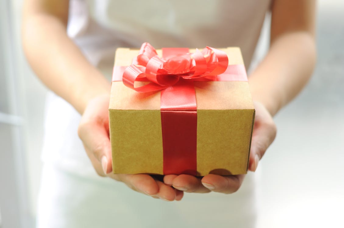 Free Person Holding a Gift Stock Photo