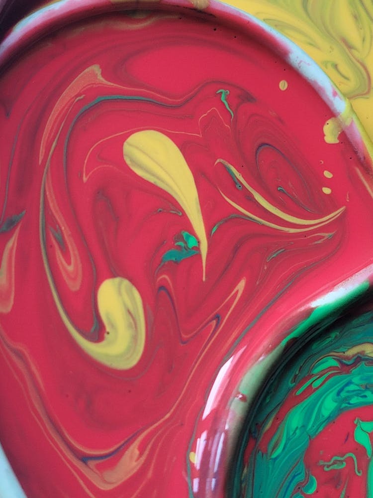 Red Paint Mixed With Yellow And Green Paint