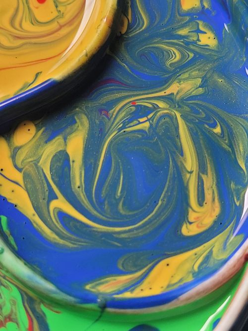 Free Vibrant close-up of swirling blue, yellow, and green paint creating a colorful abstract art piece. Stock Photo