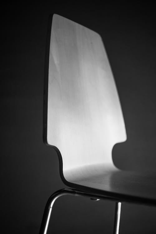 Grayscale Photo of an Empty Chair