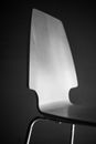 A monochromatic close-up of a modern chair in grayscale, showcasing sleek design.