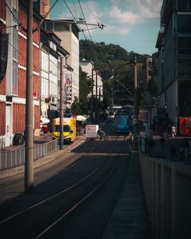 Freiburg city street featuring a tram, buildings, and vibrant urban life.