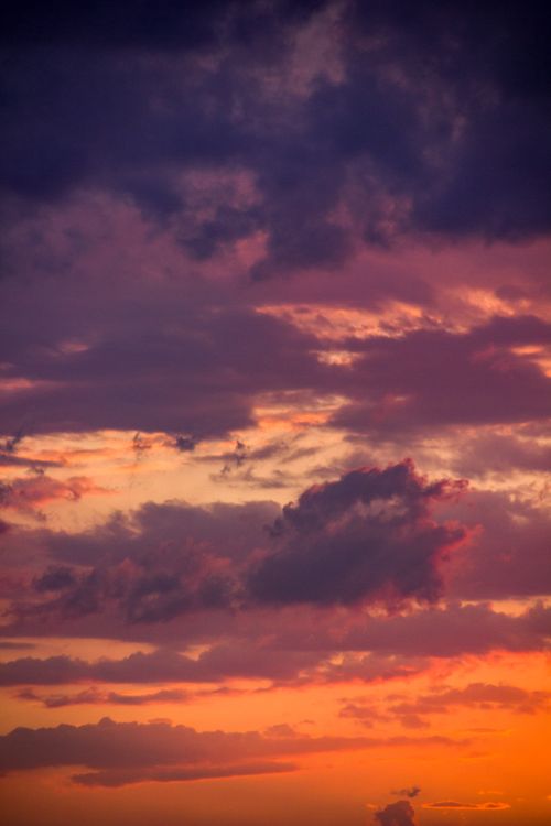 Free Capture the beauty of a dramatic sunset sky with vibrant colors and clouds. Stock Photo
